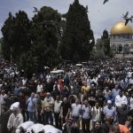 
              Palestinians gather for Friday prayers during the Muslim holy month of Ramadan, hours after Israeli police clashed with protesters at the Al Aqsa Mosque compound, in Jerusalem's Old City, Friday, April 22, 2022. (AP Photo/Mahmoud Illean)
            