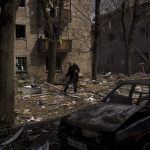 
              An elderly man walks among debris of damaged buildings after a Russian attack in Kharkiv, Ukraine, Saturday, April 16, 2022. (AP Photo/Felipe Dana)
            