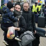 
              People return back to Ukraine, at the border crossing in Medyka, southeastern Poland, Wednesday, April 6, 2022. The reason for their return is not known. (AP Photo/Sergei Grits)
            