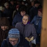 
              Ukrainian men and women queue inside a church to receive humanitarian aid donated by European Union in Bucha, in the outskirts of Kyiv, on Tuesday, April 19, 2022. Citizens of Bucha are still without electricity, water and gas after more than 44 days since the Russian invasion began. (AP Photo/Emilio Morenatti)
            