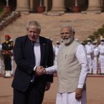 
              Indian Prime Minister Narendra Modi talks with his British counterpart Boris Johnson upon the latter's arrival at the Indian presidential palace for a ceremonial reception in New Delhi, Friday, April 22, 2022. The meeting between the two on Friday is expected to focus on expanding economic and defense ties to wean India away from its dependence on Russia, officials said. (AP Photo/Manish Swarup)
            