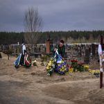 
              Volodymyr Bondar, 61, mourns next to the grave of his son Oleksandr, 32, after burying him at the cemetery in Bucha, in the outskirts of Kyiv, Ukraine on Saturday, April 16, 2022. Oleksandr, who joined the territorial Ukrainian defence as a co-ordinator was killed by a gunshot by the Russian Army. (AP Photo/Emilio Morenatti)
            