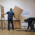 
              Municipality workers set up voting booths at a polling station in Montreuil, east of Paris, Saturday, April 23, 2022. French President Emmanuel Macron is facing off against far-right challenger Marine Le Pen in France's April 24 presidential runoff. (AP Photo/Lewis Joly)
            