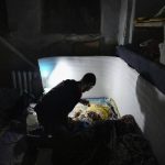 
              FILE - A man plays with a baby in a bomb shelter in Mariupol, Ukraine, Sunday, March 6, 2022. (AP Photo/Evgeniy Maloletka, File)
            