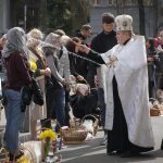 
              A Ukrainian priest blesses believers as they collect traditional cakes and painted eggs during Easter celebration in Kyiv, Ukraine, Sunday, Apr. 24, 2022. (AP Photo/Efrem lukatsky)
            