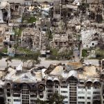 
              Destroyed houses are photographed in Irpin, on the outskirts of Kyiv, Ukraine, Saturday, April 30, 2022. (AP Photo/Emilio Morenatti)
            