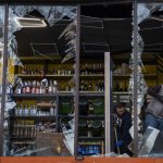 
              Employees at a liquor store clean the glass broken during an explosion in Kyiv, Ukraine on Friday, April 29, 2022. Russia struck the Ukrainian capital of Kyiv shortly after a meeting between President Volodymyr Zelenskyy and U.N. Secretary-General António Guterres on Thursday evening. (AP Photo/Emilio Morenatti)
            