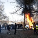 
              Protesters set fire to a police bus in the park Sveaparken in Orebro, Sweden, Friday, April 15, 2022. Police in Sweden say they are preparing for new violent clashes following riots that erupted between demonstrators and counter-protesters in the central city of Orebro on Friday ahead of an anti-Islam far-right group’s plan to burn a Quran there. (Kicki Nilsson/TT via AP)
            