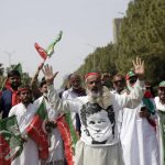 
              Supporters of ruling party Pakistan Tehreek-e-Insaf (PTI) chant slogans during a protest in Islamabad, Pakistan, Sunday, April 3, 2022. Pakistan's embattled Prime Minister Imran Khan said Sunday he will seek early elections after sidestepping a no-confidence challenge and alleging that a conspiracy to topple his government had failed. (AP Photo/Rahmat Gul)
            