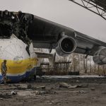 
              A Ukrainian serviceman walks by an Antonov An-225 Mriya aircraft destroyed during fighting between Russian and Ukrainian forces on the Antonov airport in Hostomel, Ukraine, Saturday, April 2, 2022. At the entrance to Antonov Airport in Hostomel Ukrainian troops manned their positions, a sign they are in full control of the runway that Russia tried to storm in the first days of the war. (AP Photo/Vadim Ghirda)
            