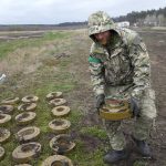 
              An interior ministry sapper collects mines on a mine field after recent battles in Irpin close to Kyiv, Ukraine, Tuesday, April 19, 2022. (AP Photo/Efrem Lukatsky)
            