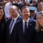 
              Israeli Prime Minister Naftali Bennett, his wife Gilat, President Isaac Herzog and his wife Michal take part in the ceremony marking Holocaust Remembrance Day at Warsaw Ghetto Square at the Yad Vashem memorial in Jerusalem, Thursday, April 28, 2022. (Amir Cohen/Pool Photo via AP)
            