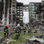 
              Emergency workers carry debris from a multi-storey building destroyed in a Russian air raid at the beginning of the Russia-Ukraine war in Borodyanka, close to Kyiv, Ukraine, Saturday, April 9, 2022.  (AP Photo/Efrem Lukatsky)
            