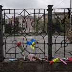 
              Flowers and toys were left on a fence at the railway station in Kramatorsk, Ukraine, Thursday, April 14, 2022. A missile strike killed at least 59 people and wounded dozens more when a rocket hit the railway station on Friday, April 8. (AP Photo/Petros Giannakouris)
            