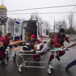 
              FILE - Ambulance paramedics move an injured man on a stretcher, wounded by shelling in a residential area, at the maternity hospital converted into a medical ward and used as a bomb shelter in Mariupol, Ukraine, Tuesday, March 1, 2022. Russian strikes on the key southern port city of Mariupol seriously wounded several people. (AP Photo/Evgeniy Maloletka, File)
            