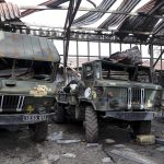 
              Damaged Ukrainian Army military trucks are parked at the Illich Iron & Steel Works Metallurgical Plant, the second largest metallurgical enterprise in Ukraine, in an area controlled by Russian-backed separatist forces in Mariupol, Ukraine, Saturday, April 16, 2022. Mariupol, a strategic port on the Sea of Azov, has been besieged by Russian troops and forces from self-proclaimed separatist areas in eastern Ukraine for more than six weeks. (AP Photo/Alexei Alexandrov)
            