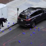 
              A crime scene investigator photographs evidence markers at the scene of a mass shooting In Sacramento, Calif. April 3, 2022. (AP Photo/Rich Pedroncelli)
            