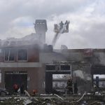 
              Firefighters work to extinguish a fire after an airstrike hit a tire shop in Lviv, Ukraine, Monday, April 18, 2022. Russian missiles hit the city of Lviv in western Ukraine on Monday, killing at least six people, Ukrainian officials said, as Moscow's troops stepped up strikes on infrastructure in preparation for an all-out assault on the east. (AP Photo/Mykola Tys)
            