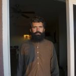 
              Wolayat Khan Samadzoi watches through the open balcony door of his apartment for the sliver of new moon to appear in the cloudless sky, where the sun had set beyond a desert mountain, in Las Cruces, N.M., Saturday, April 2, 2022. Samadzoi and thousands of other Afghans evacuated to the United States as the Taliban regained power last summer are celebrating their first Muslim holy month of Ramadan here – grateful to be safe, but agonizing over their families back home under the repressive Taliban regime. (AP Photo/Giovanna Dell'Orto)
            