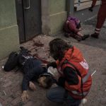 
              Emergency workers help injured civilians during a Russian bombardment in Kharkiv, Ukraine, Sunday, April 17, 2022. (AP Photo/Felipe Dana)
            