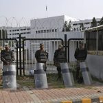 
              Pakistani paramilitary troops stand guard with riot gears outside the National Assembly, in Islamabad, Pakistan, Sunday, April 3, 2022. Pakistan's embattled prime minister faces a no-confidence vote in Parliament on Sunday and the opposition said it has the numbers to win after Imran Khan's allies and partners in a fragile coalition abandoned him. (AP Photo/Anjum Naveed)
            