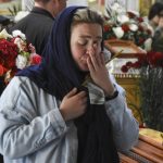
              A woman cry during a funeral ceremony for Kira Glodan, three-month-old, her mother Valerya Glodan, 28, and grandmother Lyudmila Yavkina, 54, killed in their apartment by shelling, at the Transfiguration Cathedral in Odessa, Ukraine, Wednesday, April 27, 2022. According Ukrainian officials five people including a three-month-old infant were killed and 18 injured in a missile attack in the Black Sea port city of Odesa on last Saturday, April 23. (AP Photo/Max Pshybyshevsky)
            