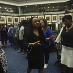 Rep. Dotie Joseph, D-North Miami leads fellow Democrat protesters in prayer as debate stops on Senate Bill 2-C: Establishing the Congressional Districts of the State in the House of Representatives Thursday, April 21, 2022 at the Capitol in Tallahassee, Fla. The session was halted on the protest, but resumed after a brief recess. (AP Photo/Phil Sears)