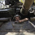 
              A Ukrainian serviceman enters a tank during the repair works after fighting against Russian forces in Donetsk region, eastern Ukraine, Wednesday, April 27, 2022. (AP Photo/Evgeniy Maloletka)
            