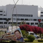 
              Pakistani paramilitary troops patrol near a billboard with the picture of Pakistan's Prime Minister Imran Khan is displayed outside the National Assembly, in Islamabad, Pakistan, Sunday, April 3, 2022. Pakistan's embattled prime minister faces a no-confidence vote in Parliament on Sunday and the opposition said it has the numbers to win after Imran Khan's allies and partners in a fragile coalition abandoned him. (AP Photo/Anjum Naveed)
            