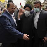 
              Iranian President Ebrahim Raisi waves to people as he attends the annual pro-Palestinian Al-Quds, or Jerusalem, Day rally in Tehran, Iran, Friday, April 29, 2022. Iran does not recognize Israel and supports Hamas and Hezbollah, militant groups that oppose it. Signs on head bands show support Iranian supreme leader Ayatollah Ali Khamenei. (AP Photo/Vahid Salemi)
            