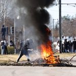 
              People burn branches to block a road during a riot in Norrkoping, Sweden, Sunday, April 17, 2022. Unrest has broken out in southern Sweden despite police moving a rally by an anti-Islam far-right group, which was planning to burn a Quran among other things, to a new location as a preventive measure.  (Stefan Jerrevang/TT News Agency via AP)
            