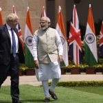 
              Indian Prime Minister Narendra Modi talks with his British counterpart Boris Johnson before their delegation level talks in New Delhi, Friday, April 22, 2022. Johnson is expected to help move India away from its dependence on Russia by expanding economic and defense ties when he meets with his Indian counterpart Friday, officials said. (AP Photo/Manish Swarup)
            