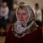 
              Olga Zhovtobrukh, 55, cries during an Easter religious service at a church in Bucha on the outskirts of Kyiv, Ukraine, Sunday, April 24, 2022. (AP Photo/Emilio Morenatti)
            