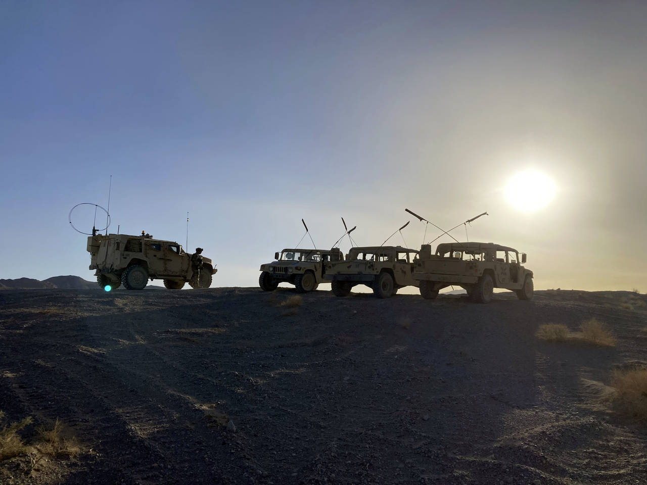 Army vehicles on the ridge, as soldiers from the 2nd Brigade, 1st Cavalry Division, prepare to atta...