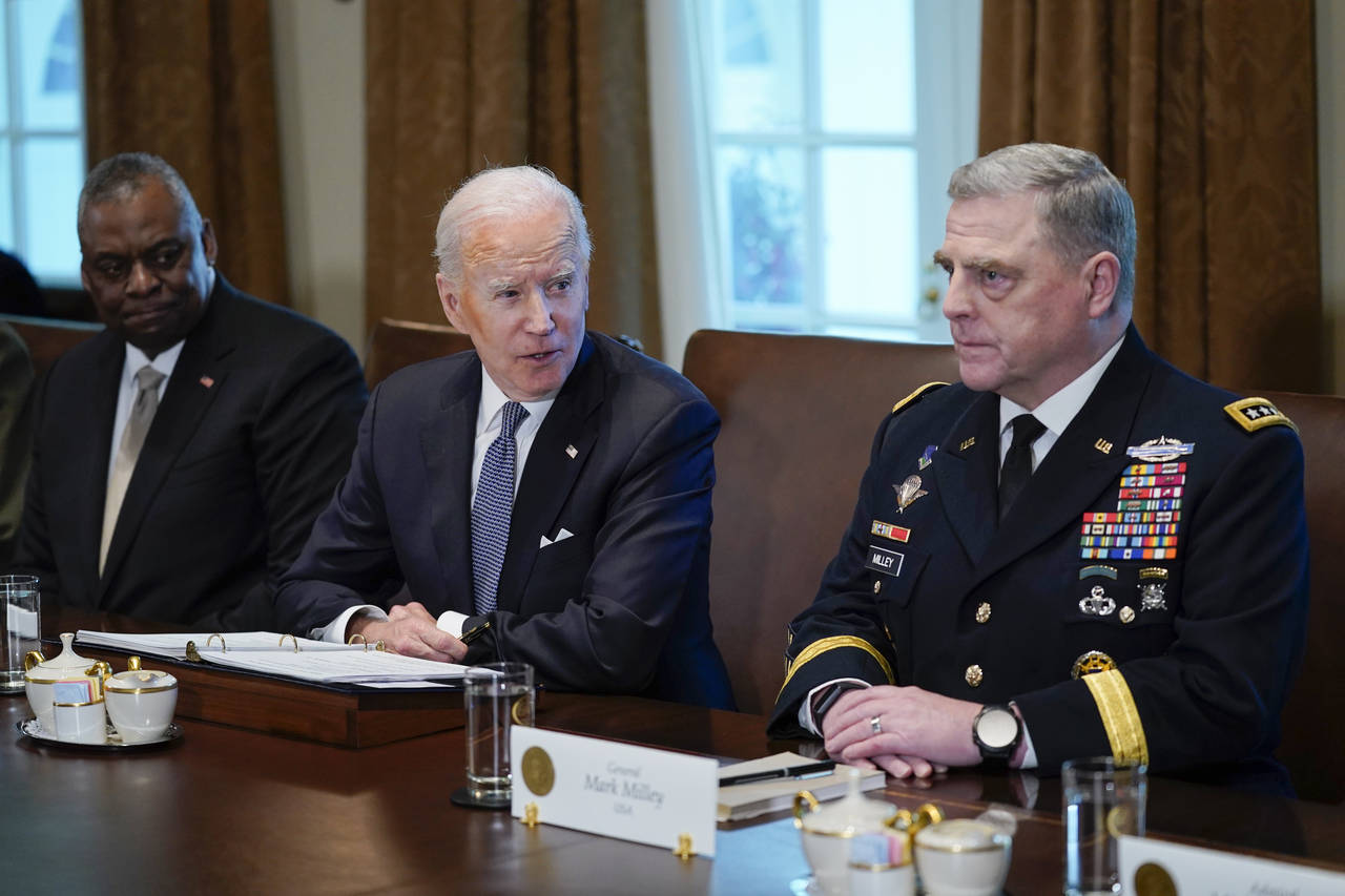 President Joe Biden listens during a meeting with Secretary of Defense Lloyd Austin, left, and Chai...