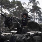 
              A Ukrainian serviceman drives on a tank in Irpin, in the outskirts of Kyiv, Ukraine, Monday, April 11, 2022. (AP Photo/Evgeniy Maloletka)
            