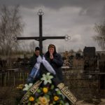 
              Galyna Bondar, mourns next to the grave of her son Oleksandr, 32, after burying him at the cemetery in Bucha, in the outskirts of Kyiv, Ukraine on Saturday, April 16, 2022. Oleksandr, who joined the territorial Ukrainian defence as a co-ordinator was killed by a gunshot by the Russian Army. (AP Photo/Emilio Morenatti)
            