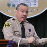 
              Los Angeles County Sheriff Alex Villanueva takes questions during a news conference, Tuesday, April 26, 2022, in  Los Angeles. Villanueva disputed allegations that he orchestrated the coverup of an incident where a deputy knelt on a handcuffed inmate's head last year. Villanueva, who oversees the nation's largest sheriff's department, also indicated that an Los Angeles Times reporter is under criminal investigation after she first reported the incident with the inmate. (AP Photo/Damian Dovarganes)
            