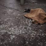 
              The body of a woman killed a Russian bombardment lies covered on a sidewalk in downtown Kharkiv, Ukraine, Sunday, April 17, 2022. (AP Photo/Felipe Dana)
            