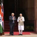 
              Indian Prime Minister Narendra Modi watches his British counterpart Boris Johnson greet the gathering upon the latter's arrival for delegation level talks in New Delhi, Friday, April 22, 2022. Johnson is expected to help move India away from its dependence on Russia by expanding economic and defense ties when he meets with his Indian counterpart Friday, officials said. (AP Photo/Manish Swarup)
            