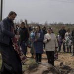 
              Grandmother Raisa Viktorovna Rodina, center right, stands next to mother Irina Tromsa, with others relatives during the funeral of Bogdan, 24, a Ukrainian paratrooper from the 95th Brigade killed during fighting against Russian troops in the north-east of the country, at the cemetery in Bucha, in the outskirts of Kyiv, on Saturday, April 23, 2022. (AP Photo/Petros Giannakouris)
            