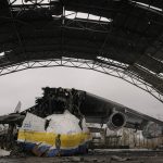 
              A Ukrainian serviceman walks by an Antonov An-225 Mriya aircraft destroyed during fighting between Russian and Ukrainian forces on the Antonov airport in Hostomel, Ukraine, Saturday, April 2, 2022. At the entrance to Antonov Airport in Hostomel Ukrainian troops manned their positions, a sign they are in full control of the runway that Russia tried to storm in the first days of the war. (AP Photo/Vadim Ghirda)
            