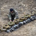 
              Interior ministry sappers prepare explosives in a hole to detonate them near a minefield, after recent battles at the village of Moshchun close to Kyiv, Ukraine, Tuesday, April 19, 2022. (AP Photo/Efrem Lukatsky)
            