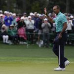 
              Tiger Woods waves to the gallery after putting out on the 18th green during the second round at the Masters golf tournament on Friday, April 8, 2022, in Augusta, Ga. (AP Photo/Robert F. Bukaty)
            
