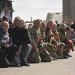 
              Ukrainian servicemen attend a funeral ceremony for their comrades Yuri Filyuk, 49, and Oleksander Tkachenko, 33, in a village of Oleksandrivka, Odesa region, Ukraine, Tuesday, April 12, 2022. According to Ukrainian servicemen, these two were killed by a Russian missile hit their military base in Krasnoselka, Odesa region, on April 7. (AP Photo/Max Pshybyshevsky)
            