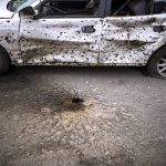 
              A car is photographed damaged by the shrapnel of an explosion in Irpin, in the outskirt of Kyiv, Ukraine on Saturday, April 30, 2022. (AP Photo/Emilio Morenatti)
            
