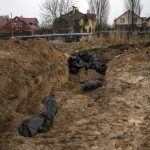 
              A mass grave in Bucha, on the outskirts of Kyiv, Ukraine, Sunday, April 3, 2022. Ukrainian troops are finding brutalized bodies and widespread destruction in the suburbs of Kyiv, sparking new calls for a war crimes investigation and sanctions against Russia. (AP Photo/Rodrigo Abd)
            