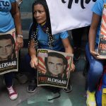 Demonstrators hold posters with the image of Alex Saab who has been extradited to the U.S.,  during a demonstration demanding his release, in the Petare neighborhood of Caracas, Venezuela, Monday, April 4, 2022. Saab, a close ally of Venezuela's President Nicolas Maduro, who prosecutors in the U.S. believe could be the most significant witness ever about corruption in the South American country, was extradited from Cabo Verde and is now in U.S. custody. (AP Photo/Ariana Cubillos)
