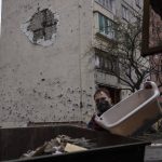 
              A man throws debris from his destroyed house in a garbage cart in Irpin, on the outskirts of Kyiv, on Thursday, April 21, 2022. Citizens of Irpin are still without electricity, water and gas after since the Russian invasion began. (AP Photo/Petros Giannakouris)
            