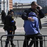 
              A man hugs a woman after Russian shelling at the railway station in Kramatorsk, Ukraine, Friday, April 8, 2022. Hours after warning that Ukraine's forces already had found worse scenes of brutality in a settlement north of Kyiv, President Volodymyr Zelenskyy said that “thousands” of people were at the station in Kramatorsk, a city in the eastern Donetsk region, when it was hit by a missile. (AP Photo/Andriy Andriyenko)
            